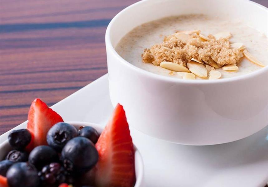 A bowl of fruit and a bowl of oatmeal