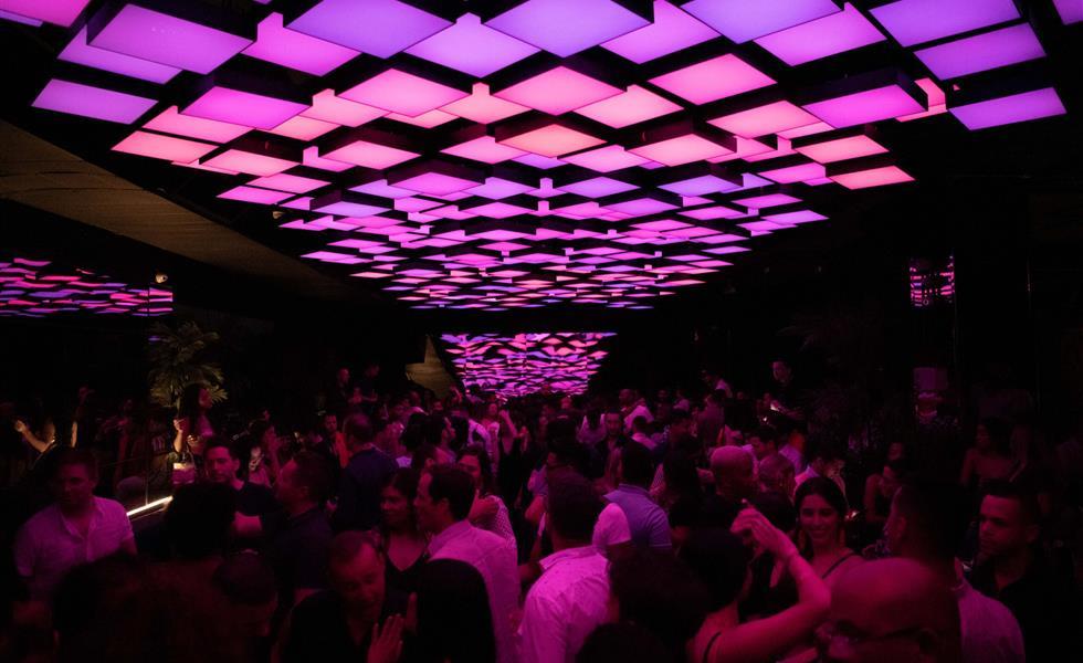 Fifty eight club with pink and purple light tiles on the ceiling