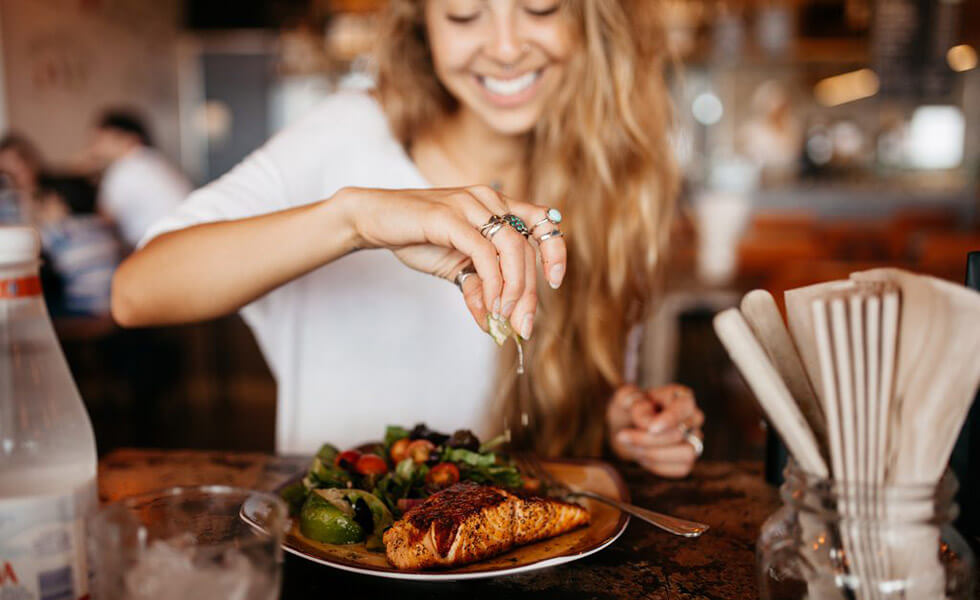 Woman squeezing a lime onto a meal