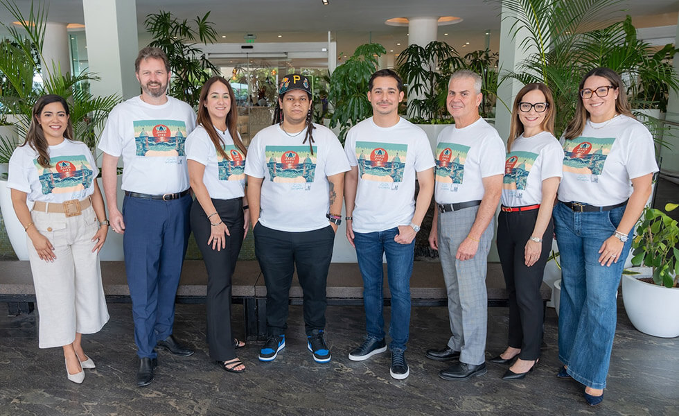 Group of people standing together in matching white graphic t-shirts