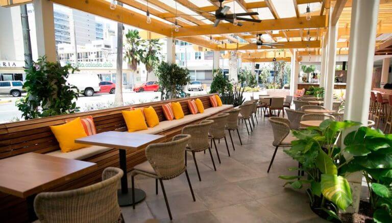 Serafina Restaurant with a long bench and rattan chairs