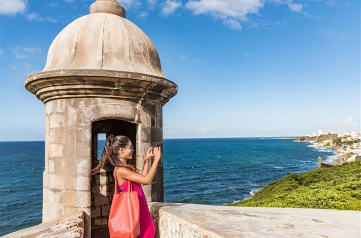 A girl taking photos on a cliff