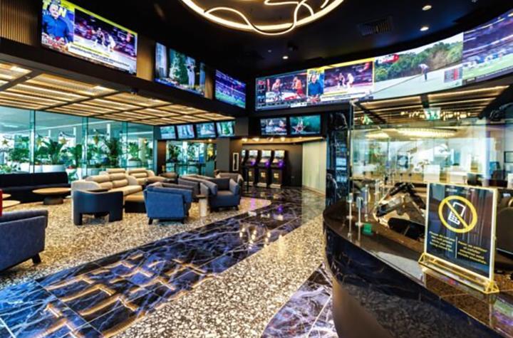 Casino del Mar interior with stone and marble floors, a modern decorative chandelier, and a lounge area