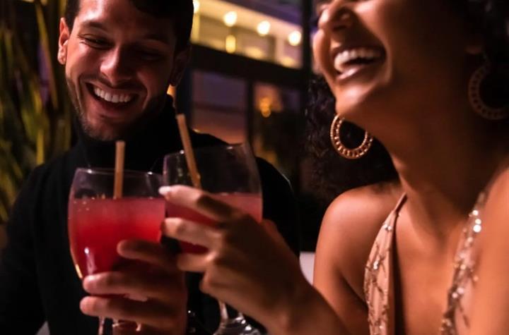 A guy and girl drinking