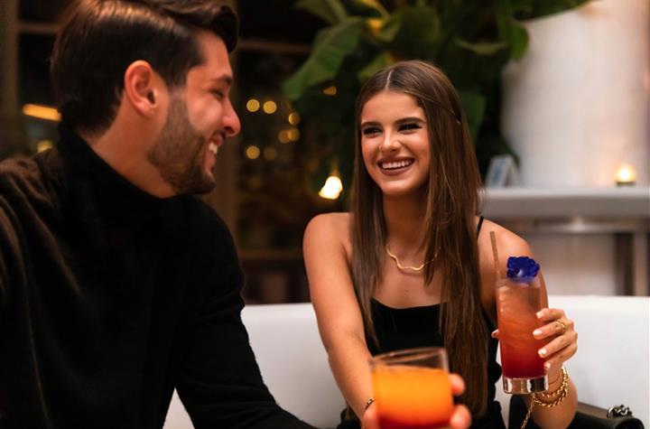 A couple enjoying drinks with each other