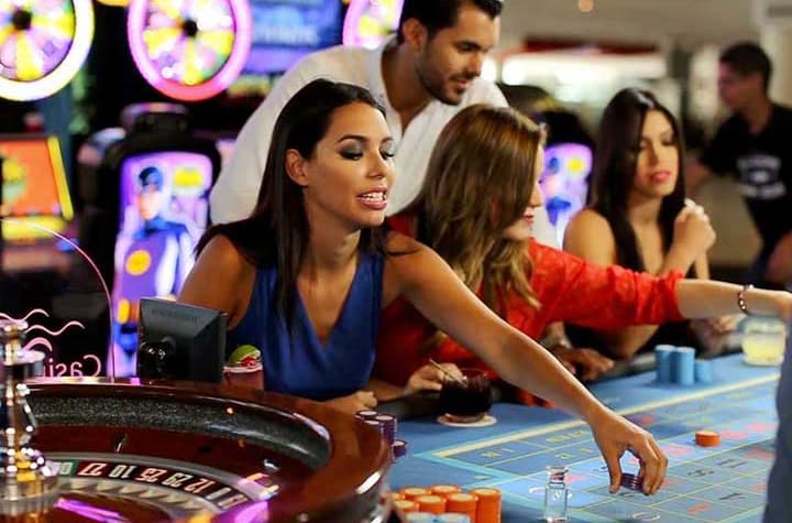Woman in casual evening wear with a smoky eye placing bets for roulette
