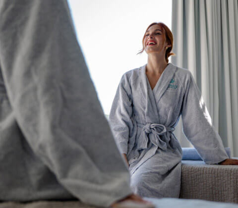 Woman laughing in a robe