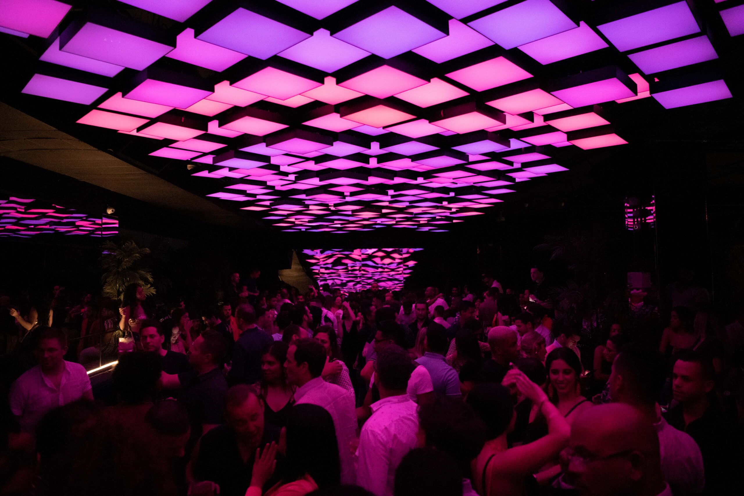 fifty eight nightclub - people dancing and purple lights.