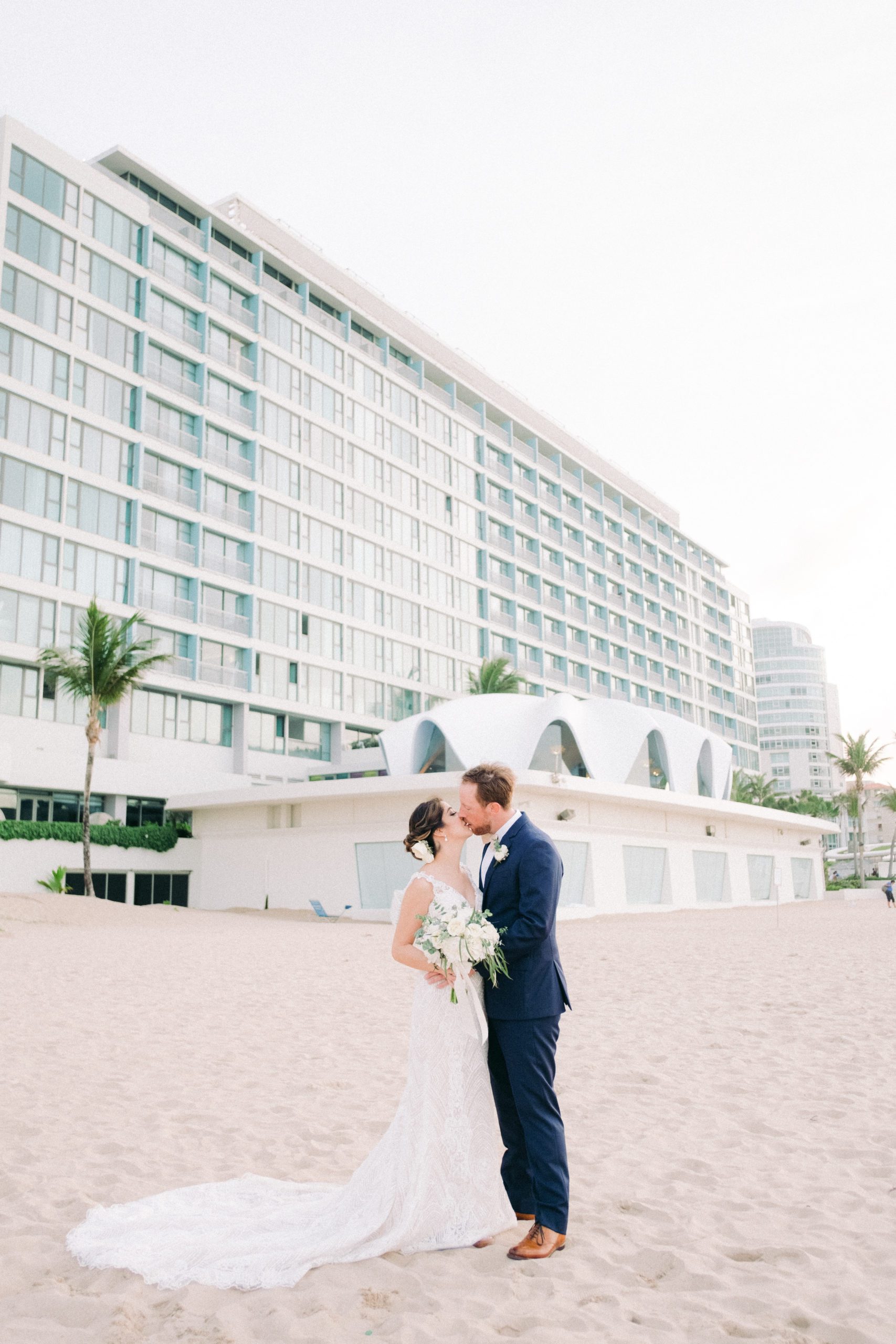 Wedding couple in front of la concha condado beach san juan