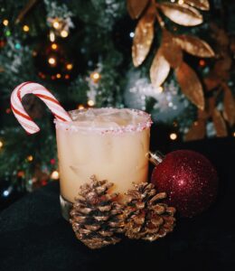 drink with candy cane and christmas decorations