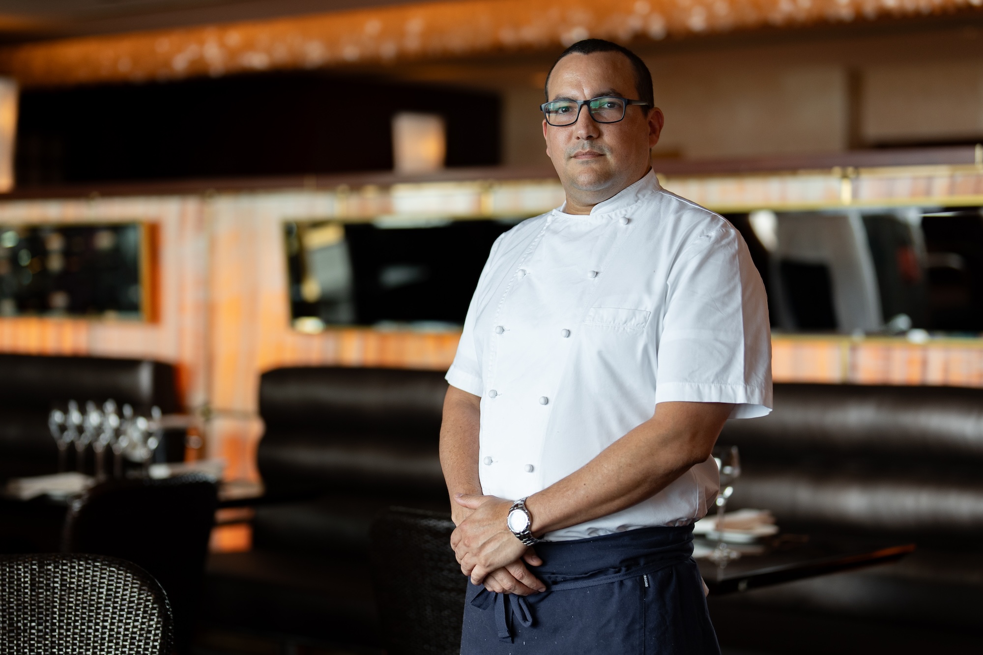 Chef Rosado standing at restaurant