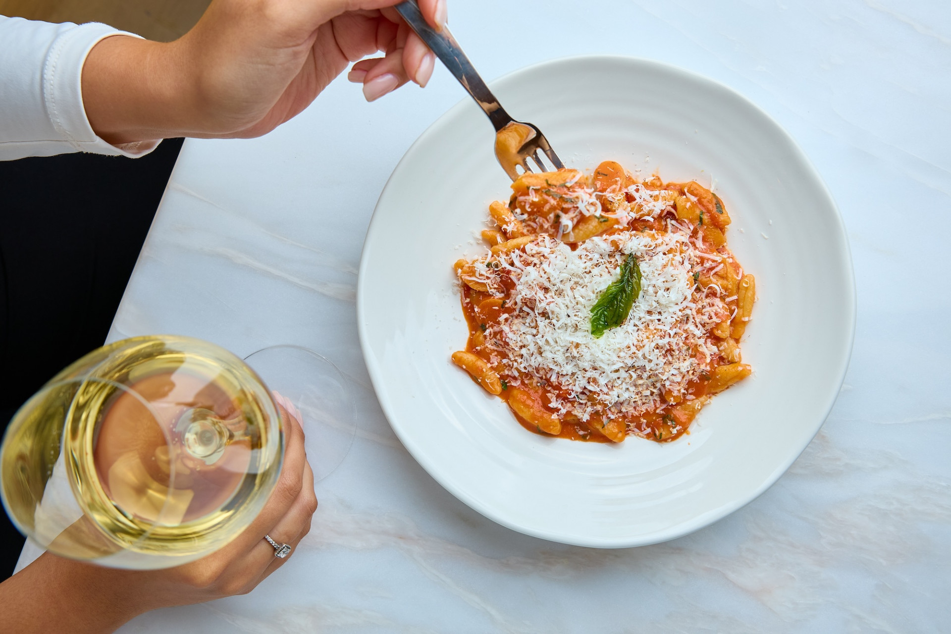 Pasta plate and wine glass at table at levant restaurant